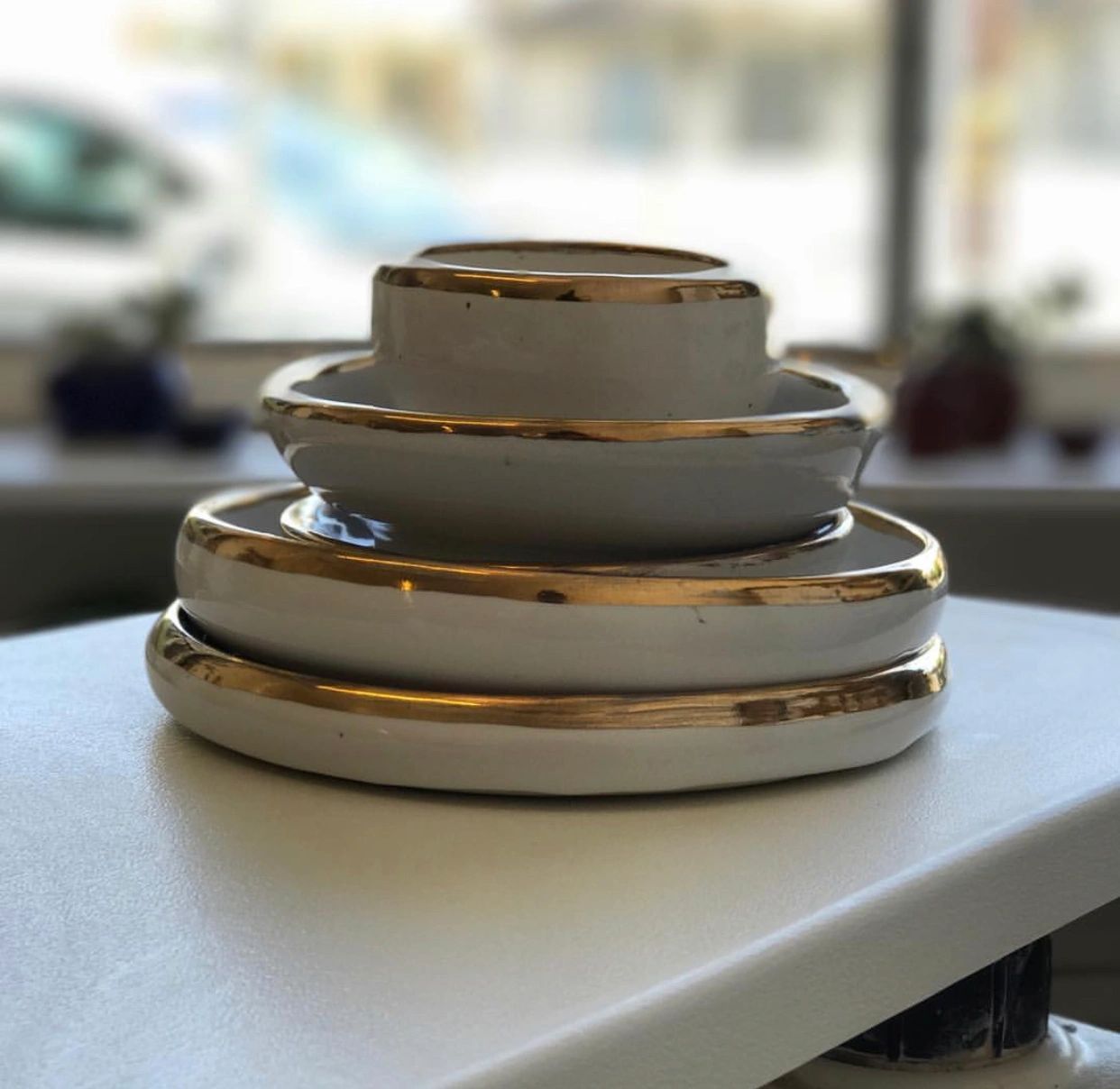 White ceramic dishes with gold rims